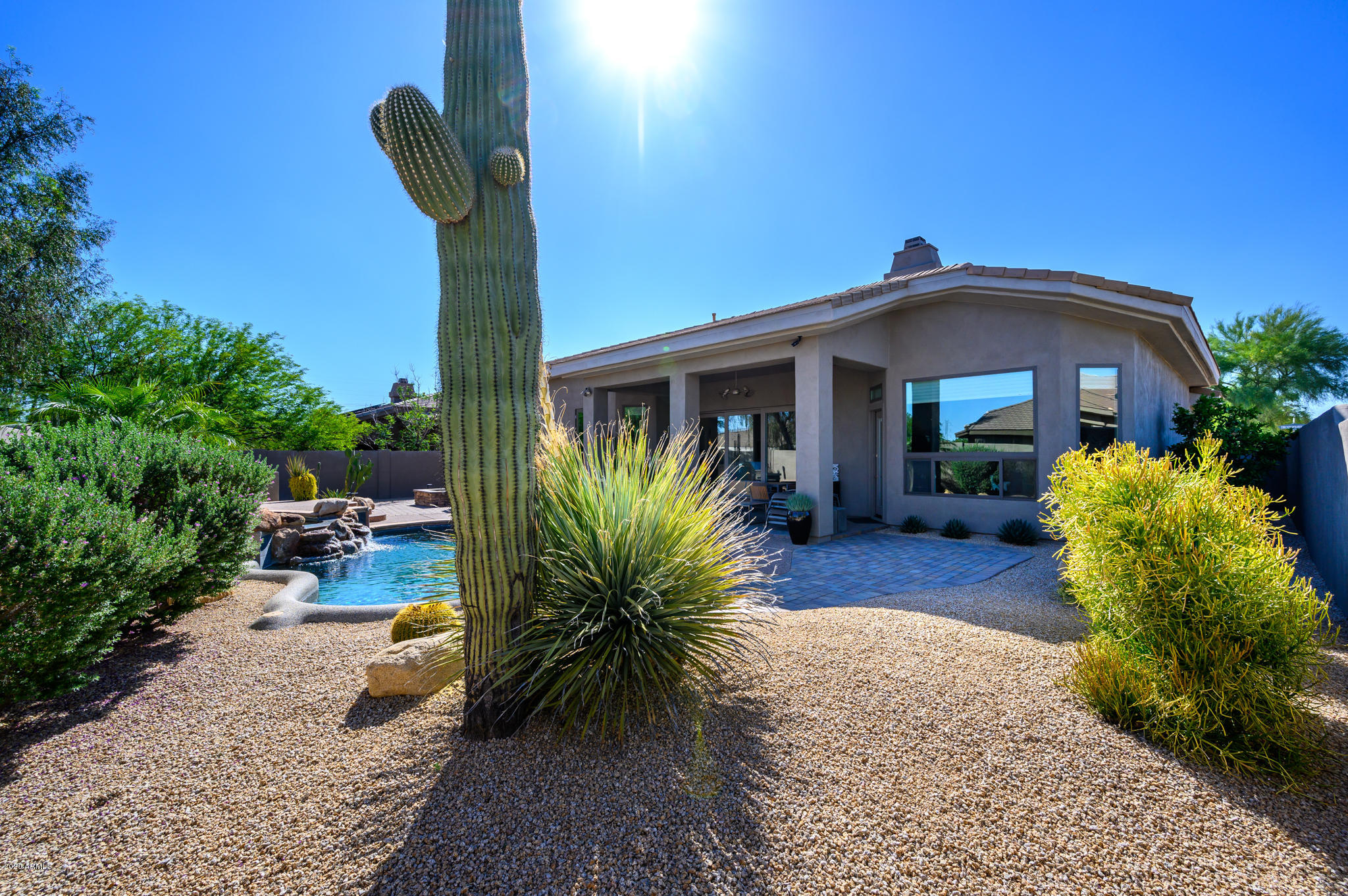 7953 East Thunderhawk Road Scottsdale, AZ 85255 - Photo 37 of 40 a front view of a house with garden