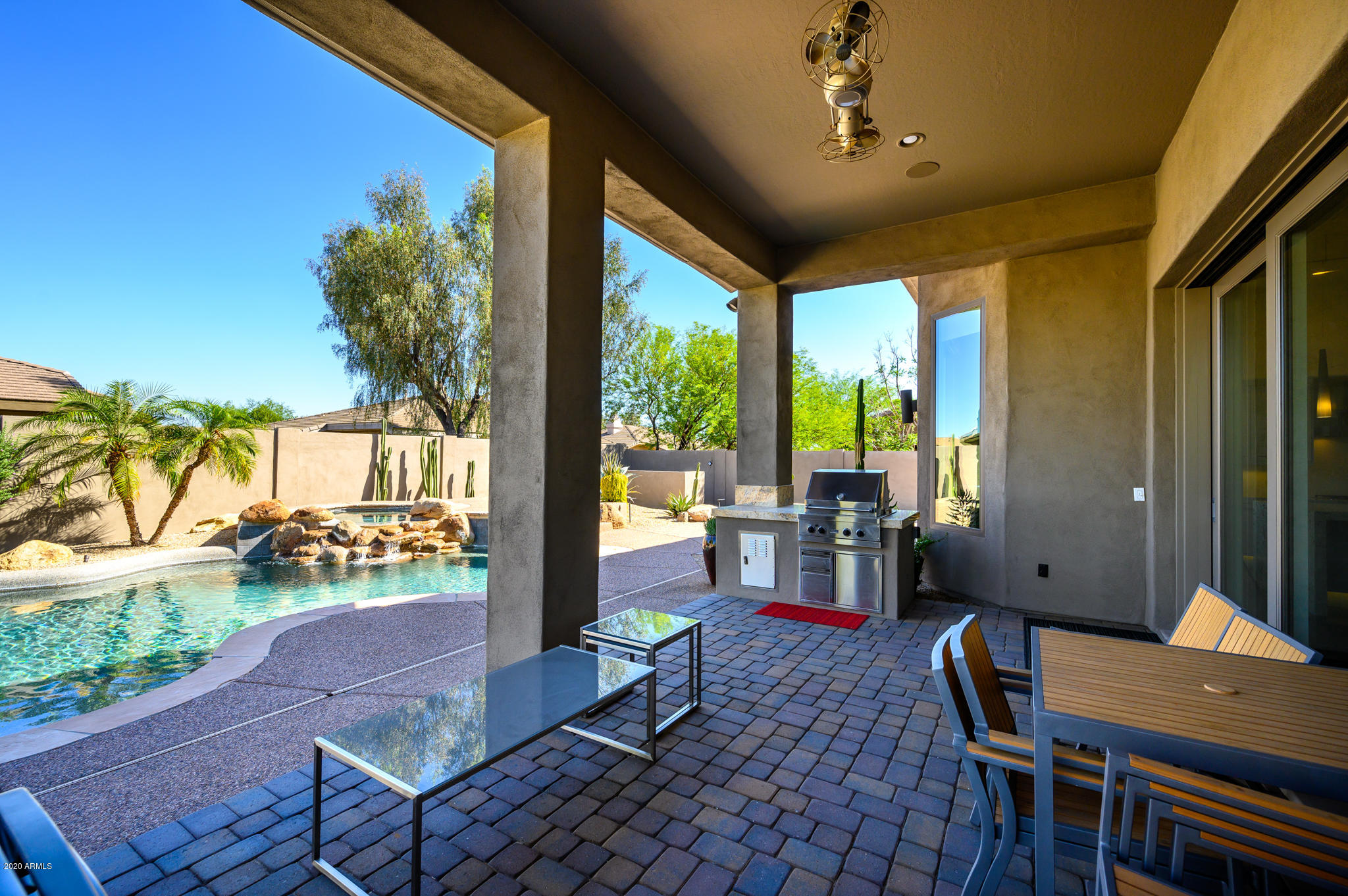 7953 East Thunderhawk Road Scottsdale, AZ 85255 - Photo 4 of 40 a living room with patio furniture and a floor to ceiling window