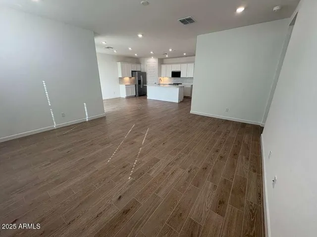 a view of a kitchen with a sink and a refrigerator