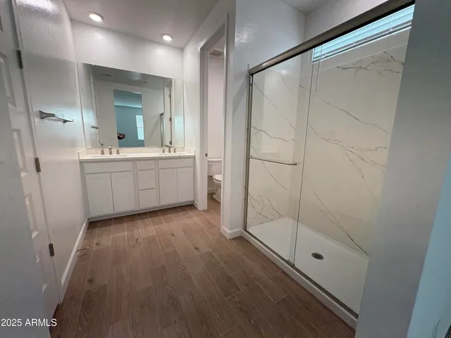 a bathroom with a shower and a sink