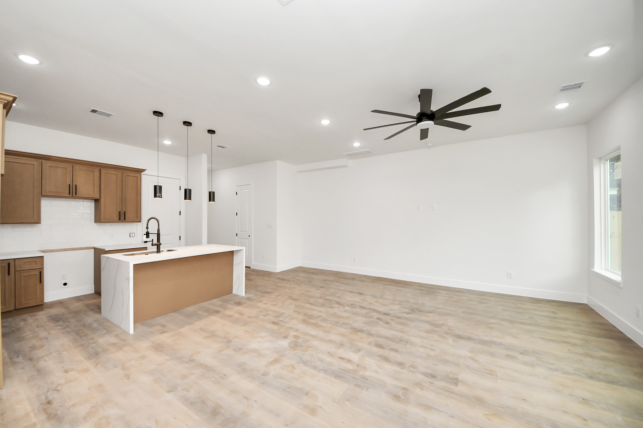 8206 Colonial Lane Houston, TX 77051 - Photo 17 of 31 a view of a kitchen with furniture and a ceiling fan