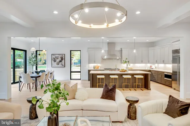 a living room with furniture kitchen and a large window
