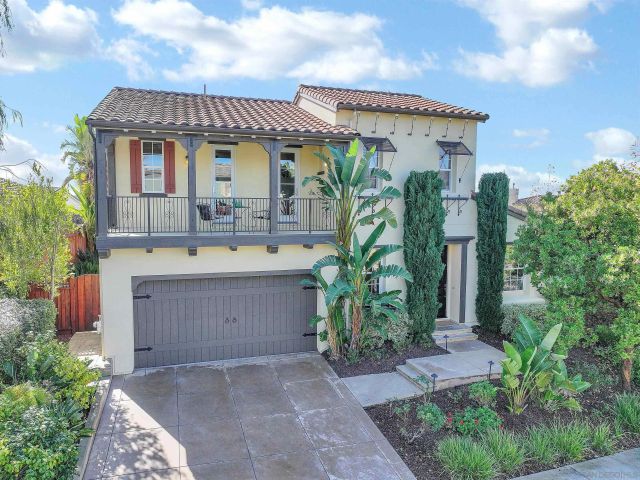 a living room with furniture and potted plant