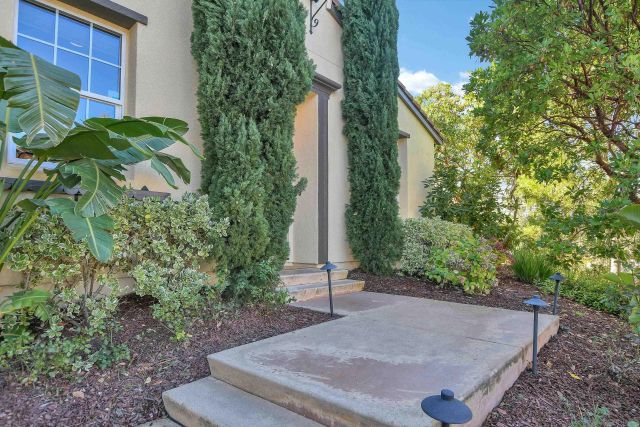 a living room with furniture and floor to ceiling windows