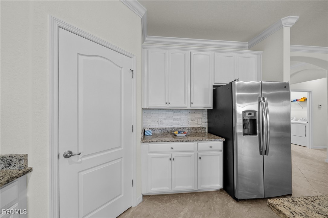 10061 Avalon Lake Circle, Unit 104 Fort Myers, FL 33913 - Photo 16 of 46 a kitchen with a refrigerator sink and cabinets
