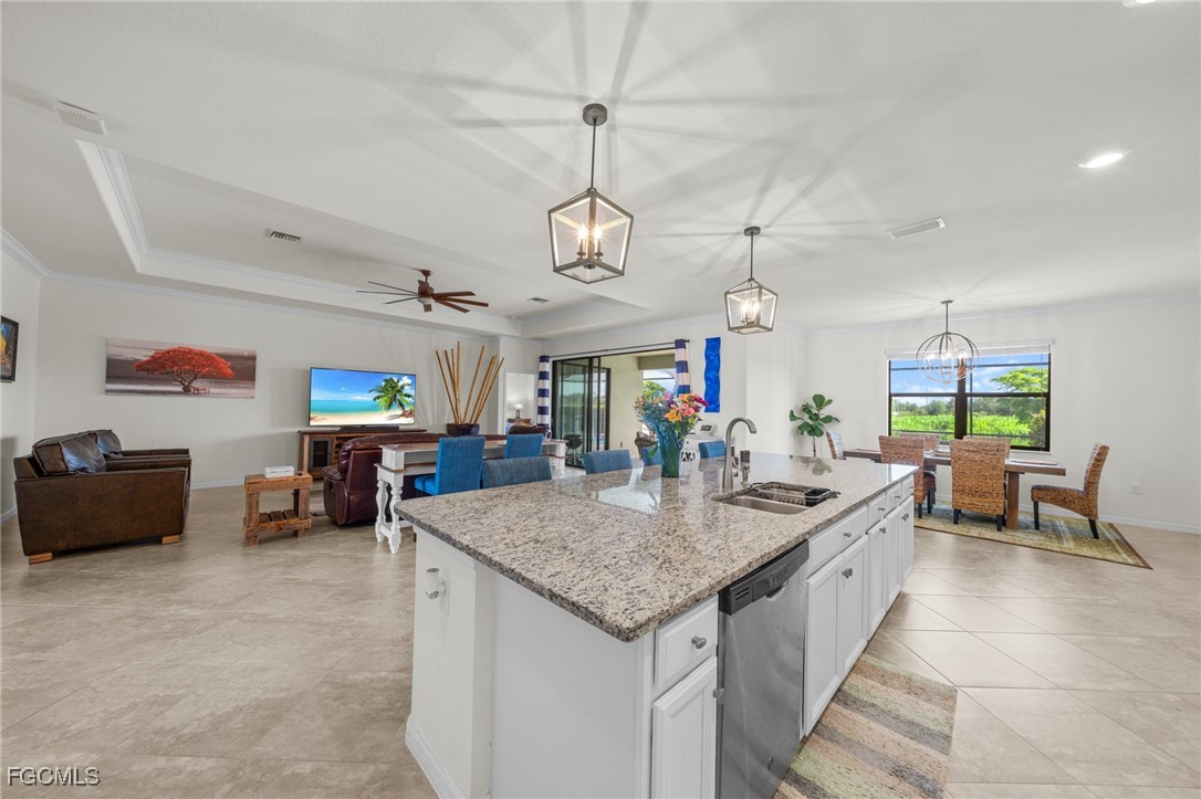 10061 Avalon Lake Circle, Unit 104 Fort Myers, FL 33913 - Photo 18 of 46 a view of a dining room and livingroom with furniture wooden floor a chandelier