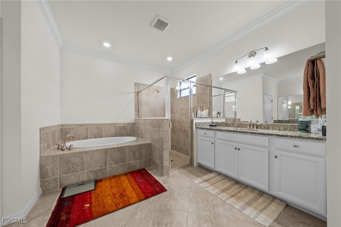 10061 Avalon Lake Circle, Unit 104 Fort Myers, FL 33913 - Photo 24 of 46 a bathroom with a tub sink and mirror