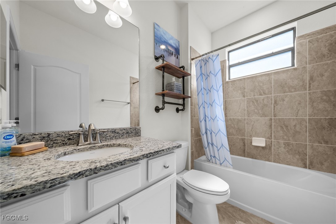 10061 Avalon Lake Circle, Unit 104 Fort Myers, FL 33913 - Photo 28 of 46 a bathroom with a granite countertop sink toilet and shower
