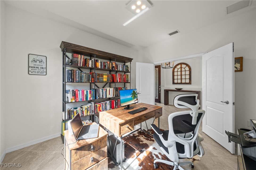 10061 Avalon Lake Circle, Unit 104 Fort Myers, FL 33913 - Photo 30 of 46 a workspace with furniture and a bookshelf