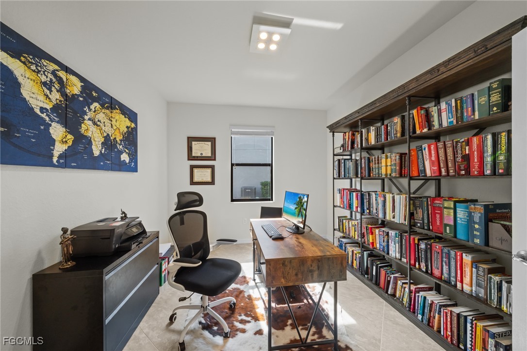 10061 Avalon Lake Circle, Unit 104 Fort Myers, FL 33913 - Photo 31 of 46 a view of a workspace with bookshelf