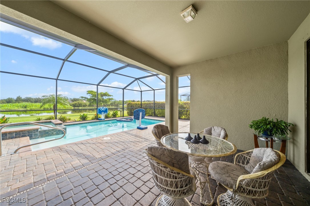 10061 Avalon Lake Circle, Unit 104 Fort Myers, FL 33913 - Photo 33 of 46 a dining room with furniture and a floor to ceiling window