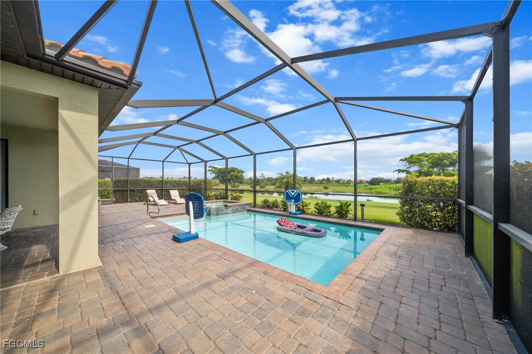 10061 Avalon Lake Circle, Unit 104 Fort Myers, FL 33913 - Photo 37 of 46 a view of a patio with a table and chairs under an umbrella