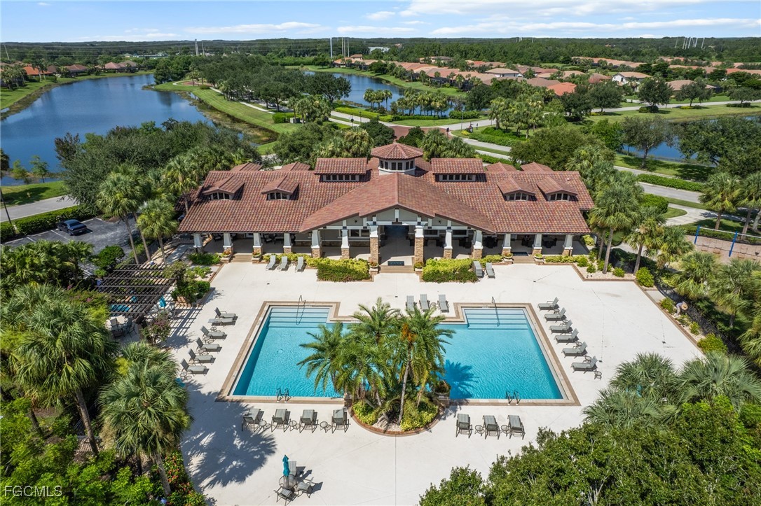 10061 Avalon Lake Circle, Unit 104 Fort Myers, FL 33913 - Photo 40 of 46 an aerial view of multiple houses with a yard