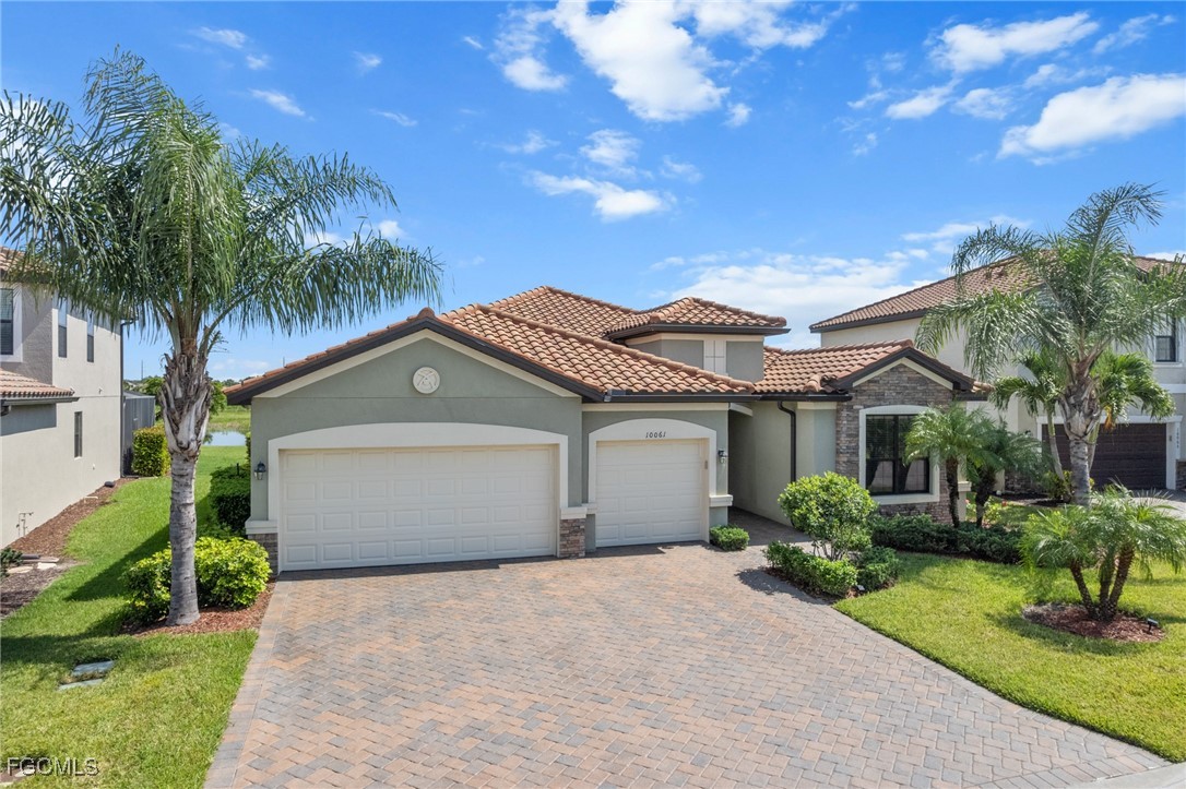 10061 Avalon Lake Circle, Unit 104 Fort Myers, FL 33913 - Photo 4 of 46 a front view of a house with a garden