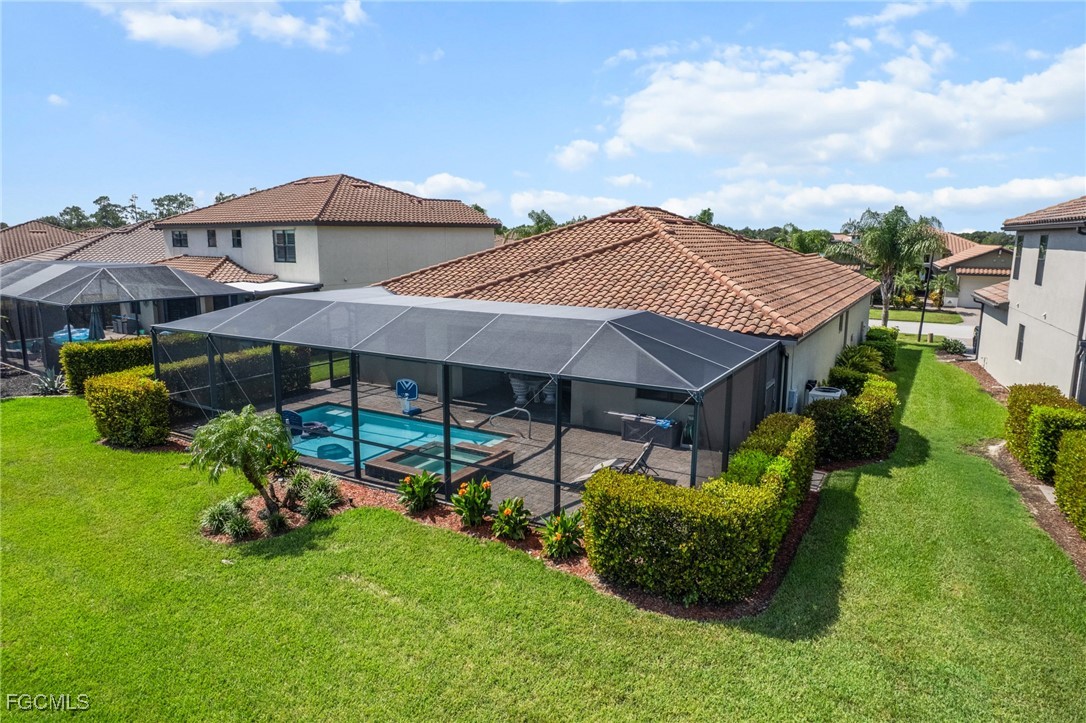10061 Avalon Lake Circle, Unit 104 Fort Myers, FL 33913 - Photo 44 of 46 a front view of a house with garden