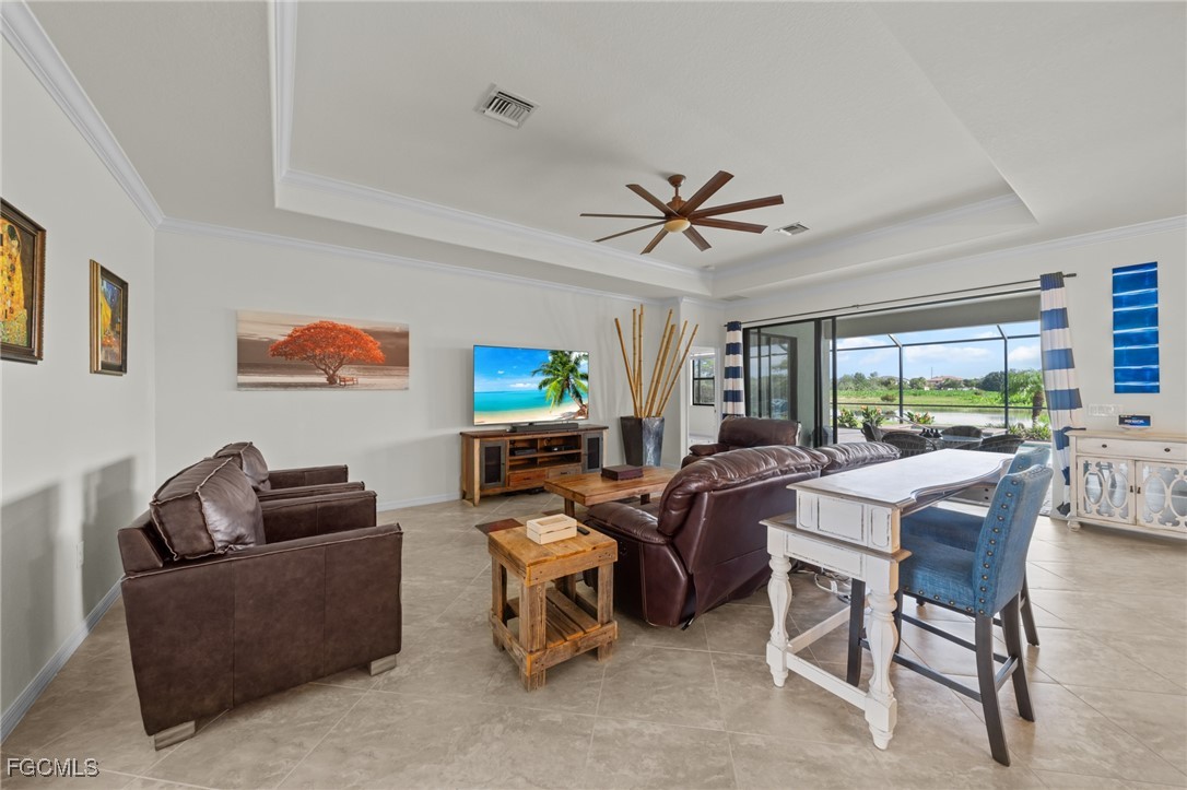 10061 Avalon Lake Circle, Unit 104 Fort Myers, FL 33913 - Photo 9 of 46 a living room with furniture a window and a flat screen tv