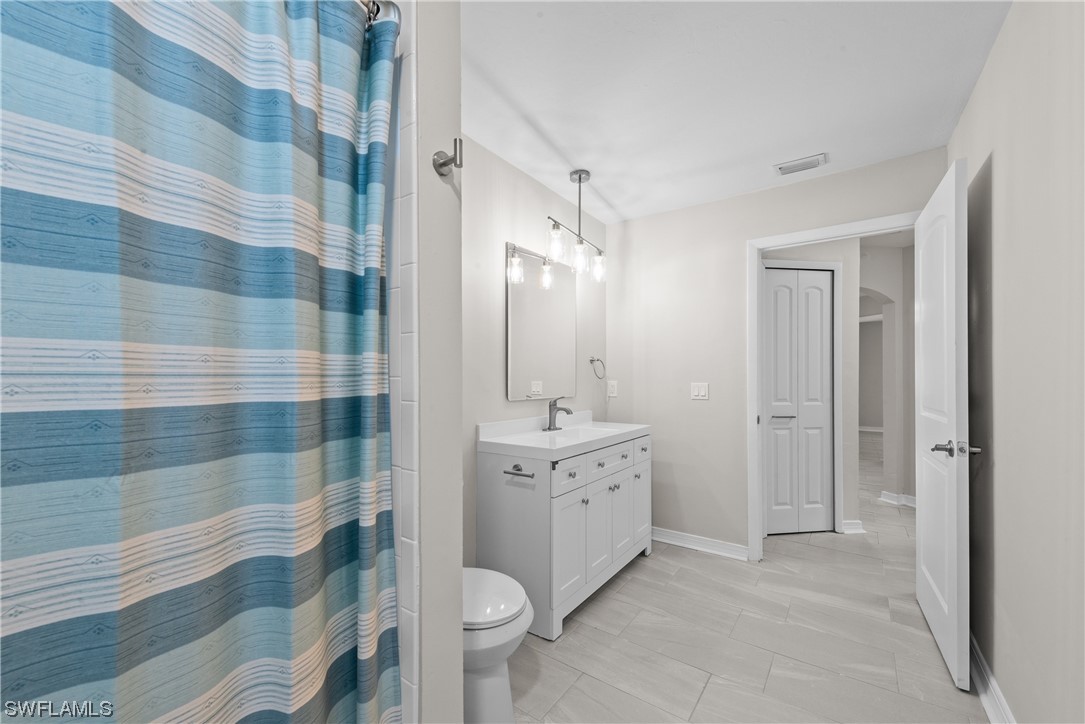 1058 Old Bridge Road North Fort Myers, FL 33917 - Photo 18 of 43 a spacious bathroom with a double vanity sink toilet mirror and shower