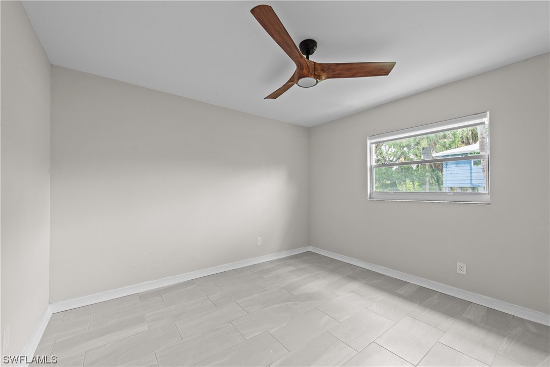 1058 Old Bridge Road North Fort Myers, FL 33917 - Photo 19 of 43 an empty room with windows and ceiling fan