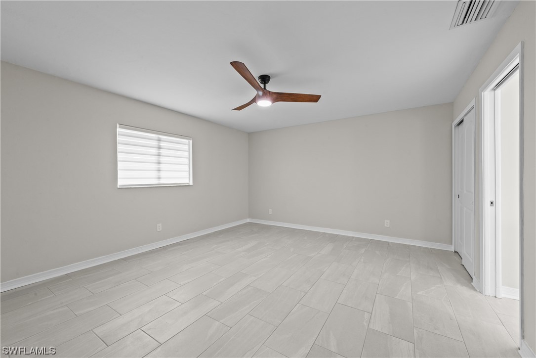 1058 Old Bridge Road North Fort Myers, FL 33917 - Photo 21 of 43 an empty room with a window and a fan