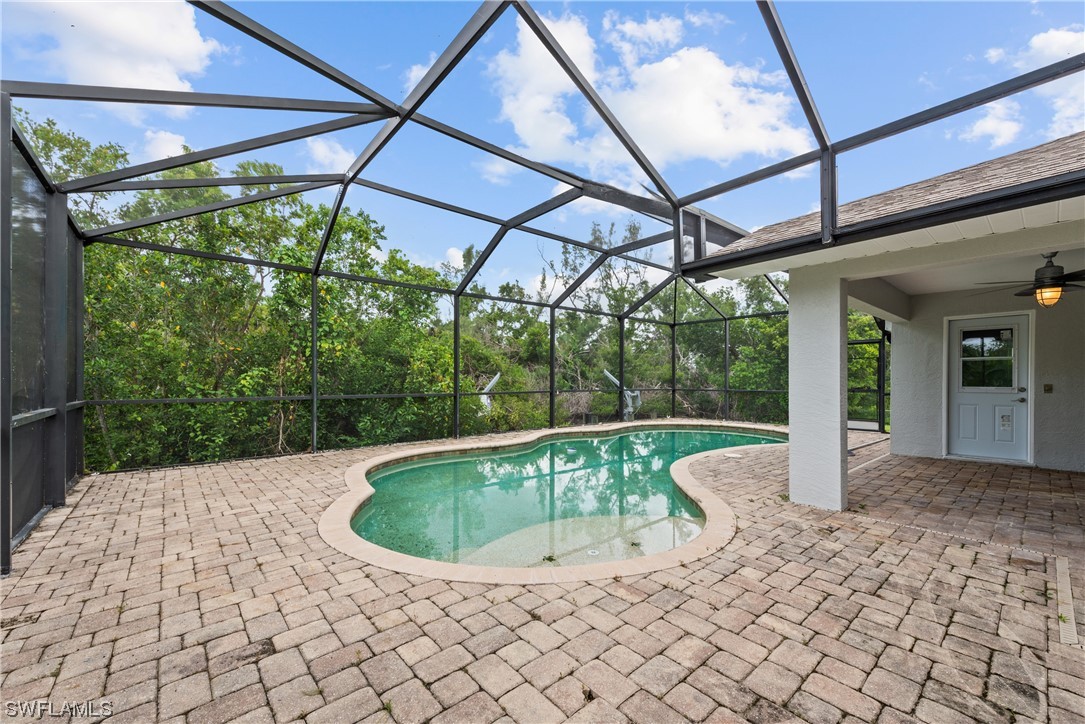 1058 Old Bridge Road North Fort Myers, FL 33917 - Photo 32 of 43 a view of a backyard with table and chairs