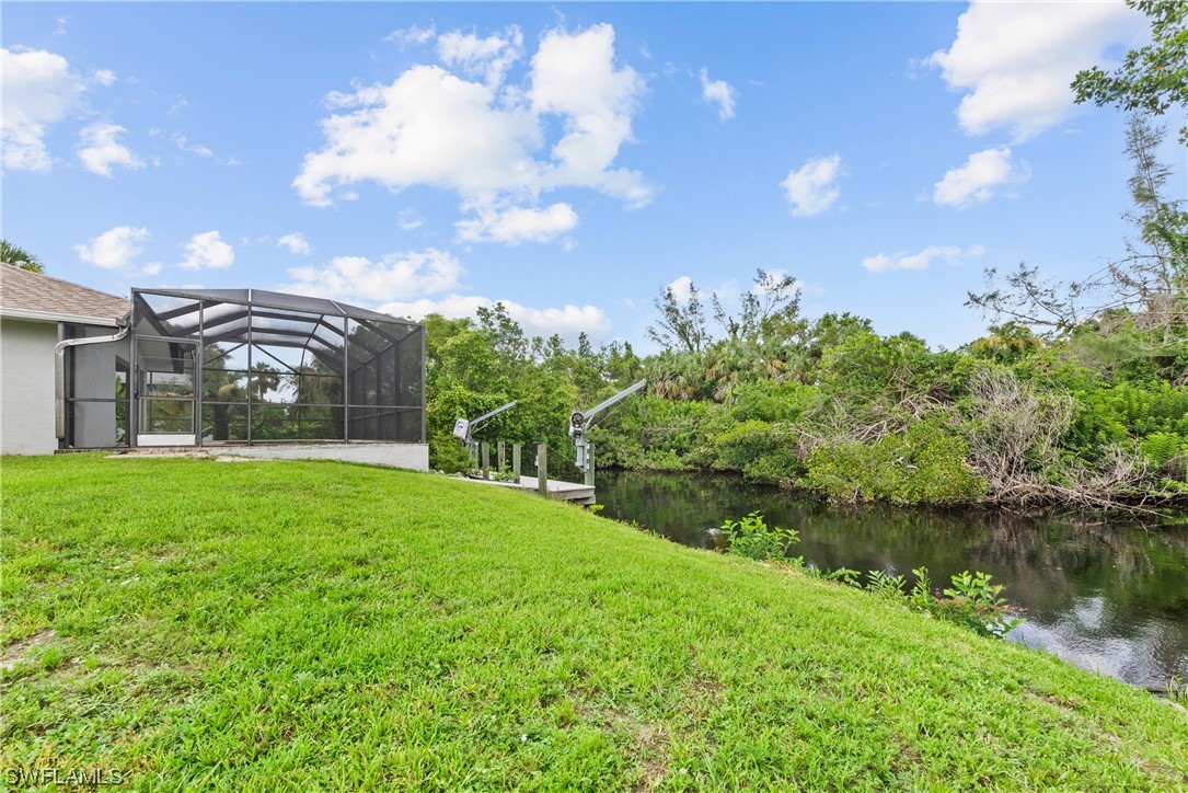 1058 Old Bridge Road North Fort Myers, FL 33917 - Photo 35 of 43 a view of a garden with a building in the background