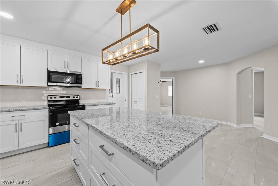 1058 Old Bridge Road North Fort Myers, FL 33917 - Photo 10 of 43 a kitchen with granite countertop a sink cabinets and stainless steel appliances