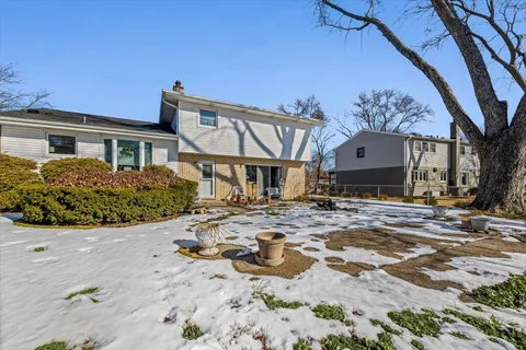 a view of a house with snow on the road