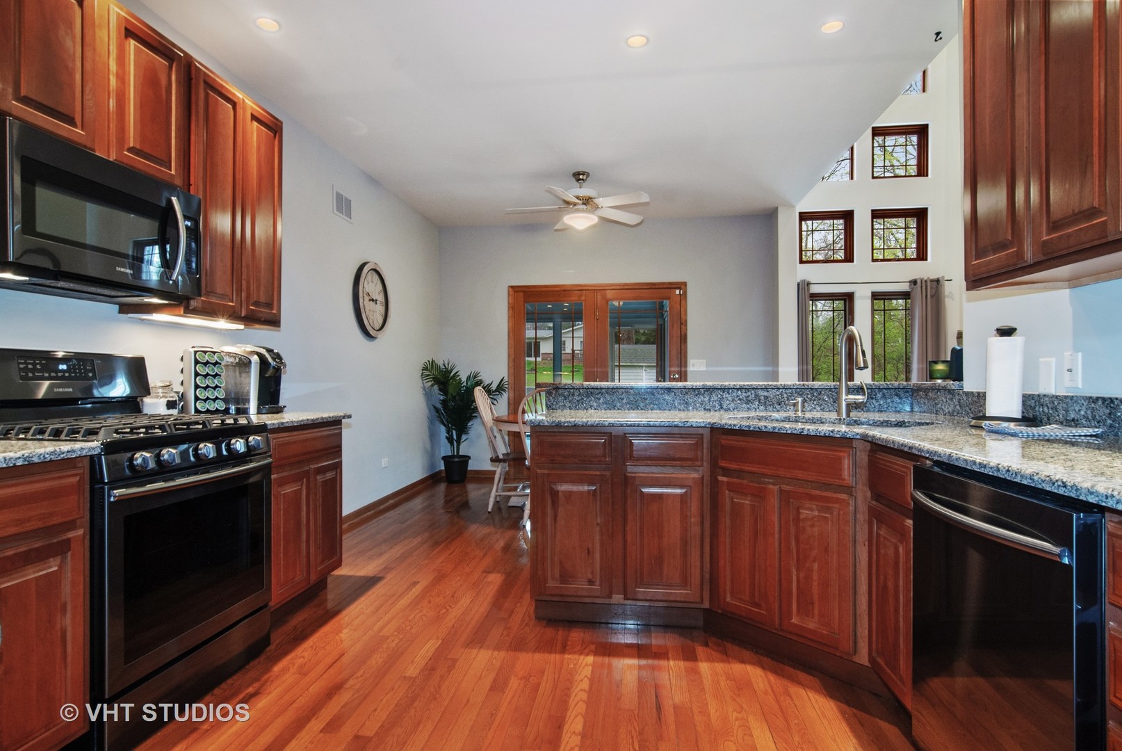 43W887 Old Midlothian Road Elburn, IL 60119 - Photo 15 of 35 a kitchen with stainless steel appliances granite countertop wooden floors and wooden cabinets