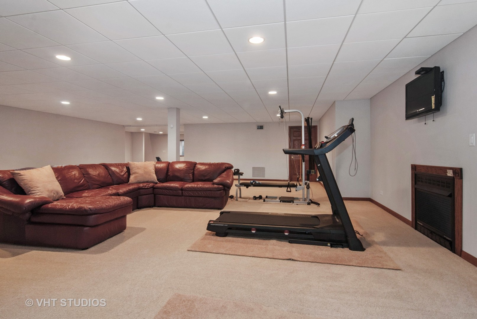 43W887 Old Midlothian Road Elburn, IL 60119 - Photo 25 of 35 a living room with furniture gym equipment and a flat screen tv