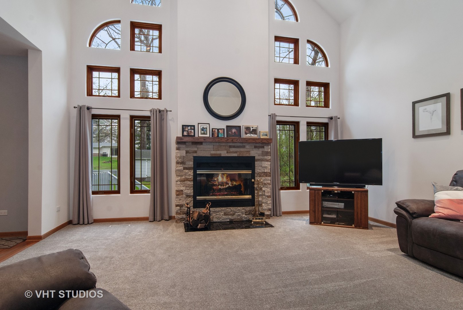 43W887 Old Midlothian Road Elburn, IL 60119 - Photo 8 of 35 a living room with furniture a flat screen tv and a fireplace