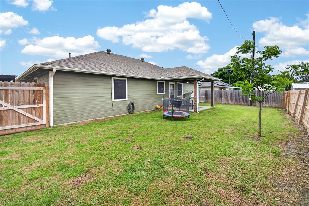 703 College Street Celeste, TX 75423 - Photo 27 of 29 a view of a house with backyard and a garden