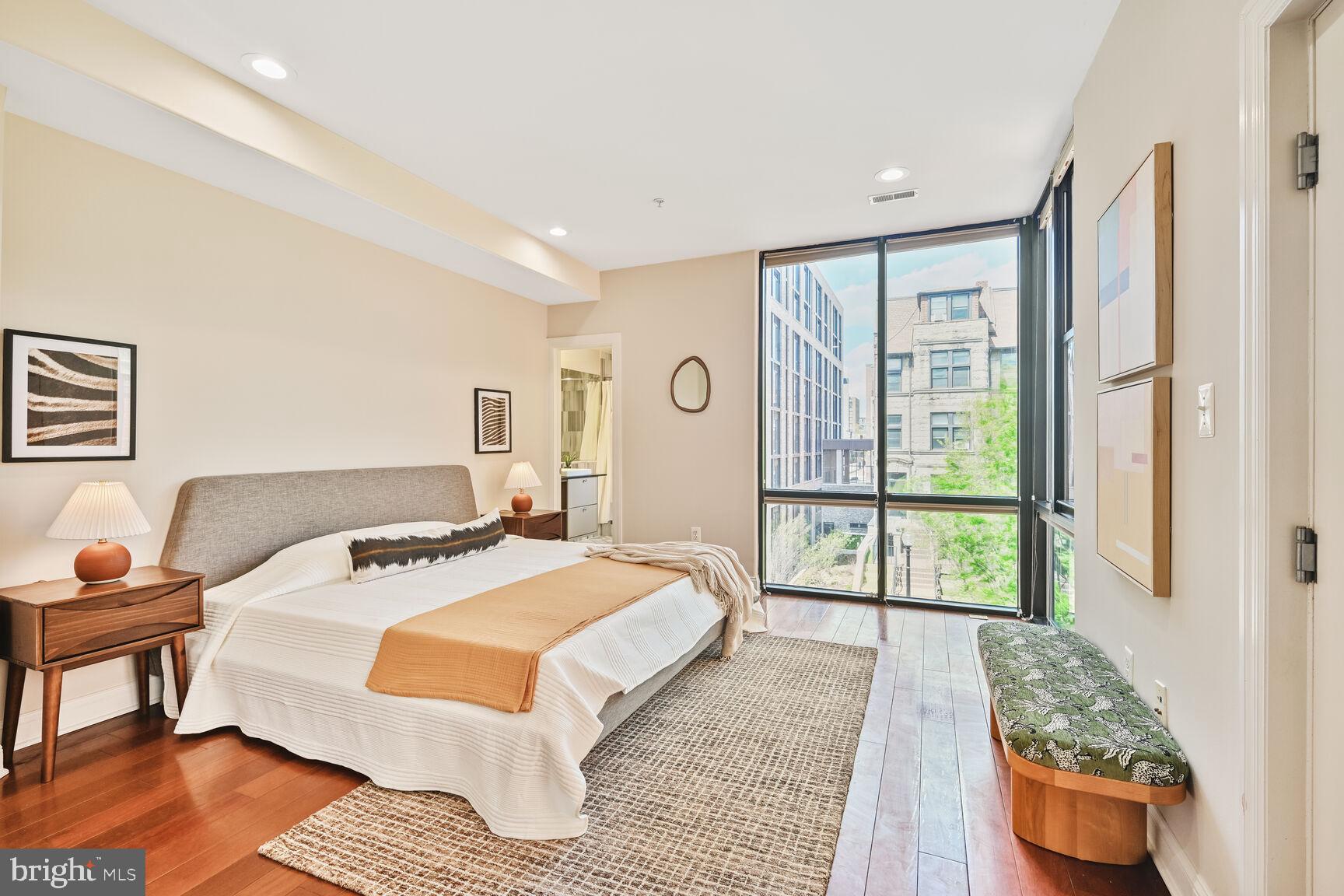 1354 Euclid Street Northwest, Unit 403A Washington, DC 20009 - Photo 11 of 26 a bedroom with a bed and wooden floor