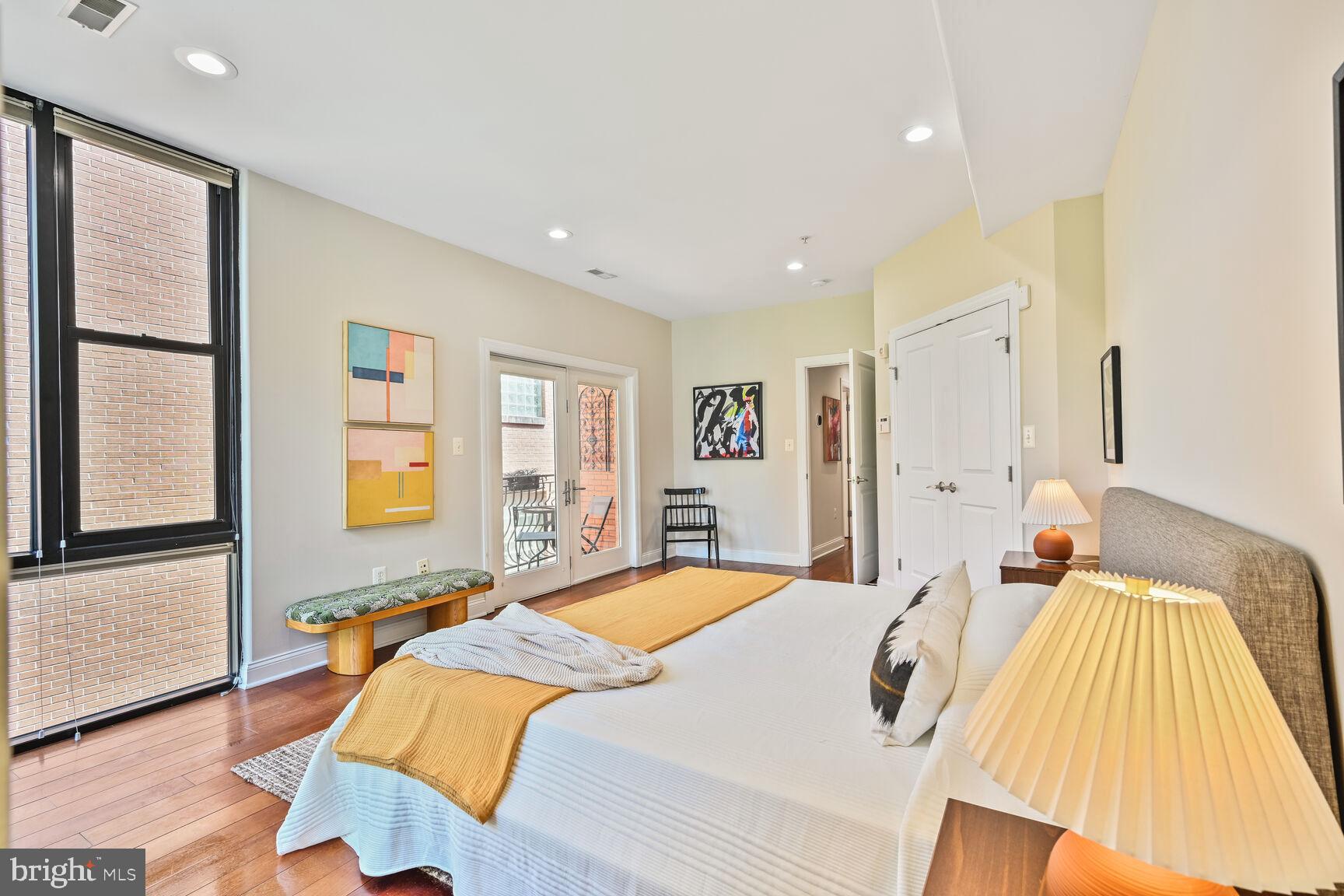 1354 Euclid Street Northwest, Unit 403A Washington, DC 20009 - Photo 12 of 26 a bedroom with a bed and a large window