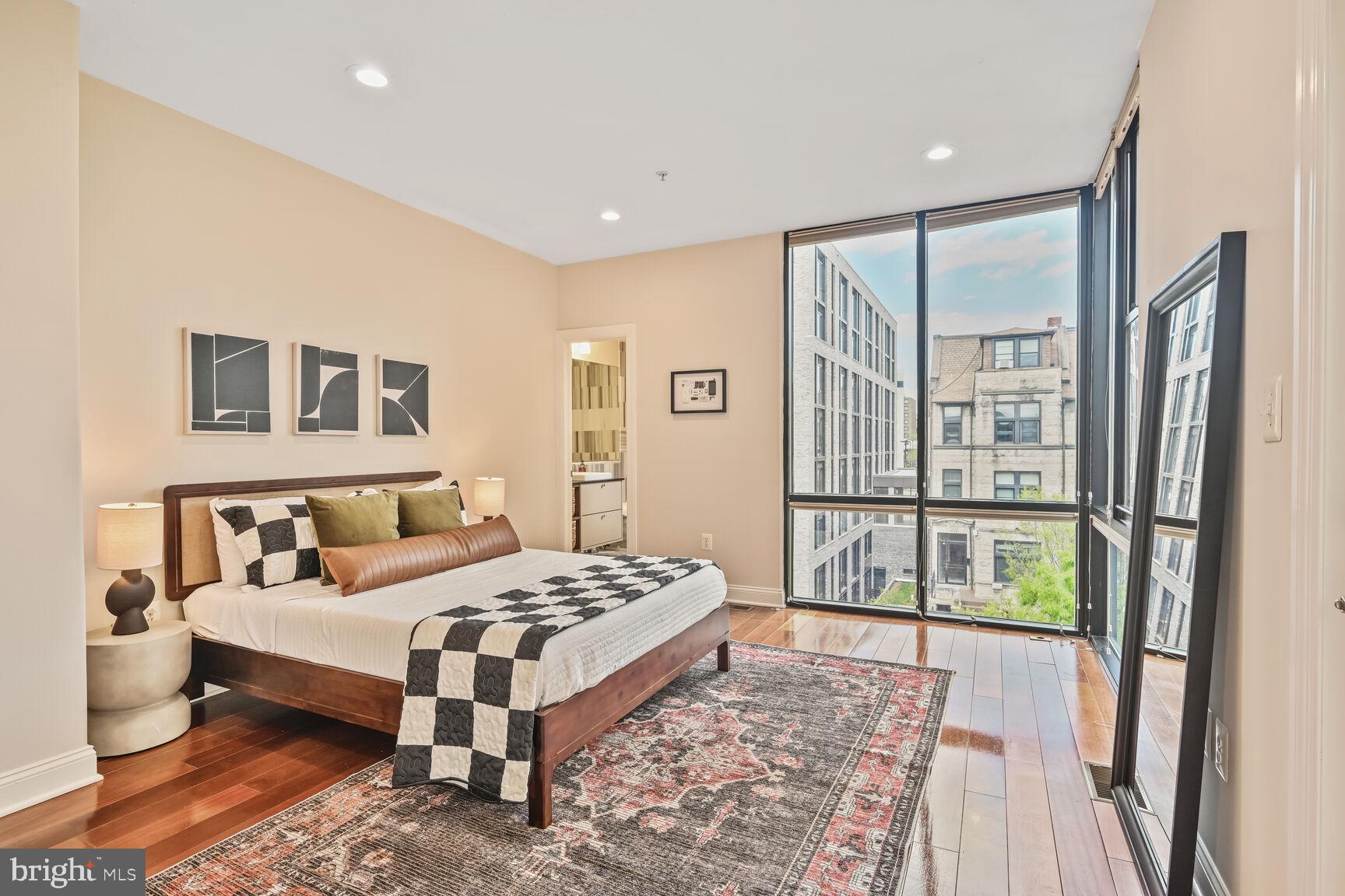 1354 Euclid Street Northwest, Unit 403A Washington, DC 20009 - Photo 14 of 26 a bedroom with a bed and a large window