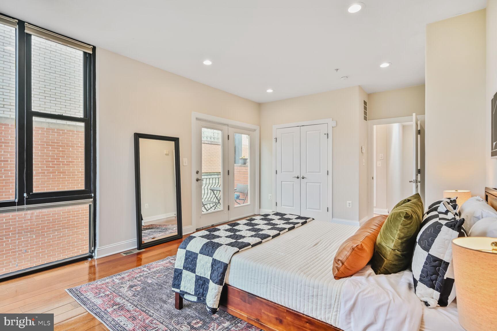 1354 Euclid Street Northwest, Unit 403A Washington, DC 20009 - Photo 15 of 26 a bedroom with a bed and wooden floor