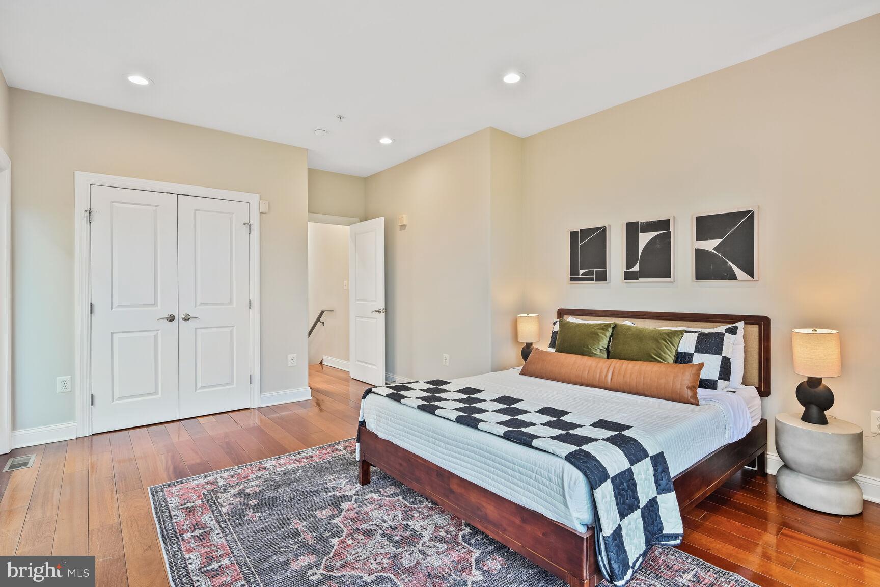 1354 Euclid Street Northwest, Unit 403A Washington, DC 20009 - Photo 16 of 26 a bedroom with a bed and wooden floor