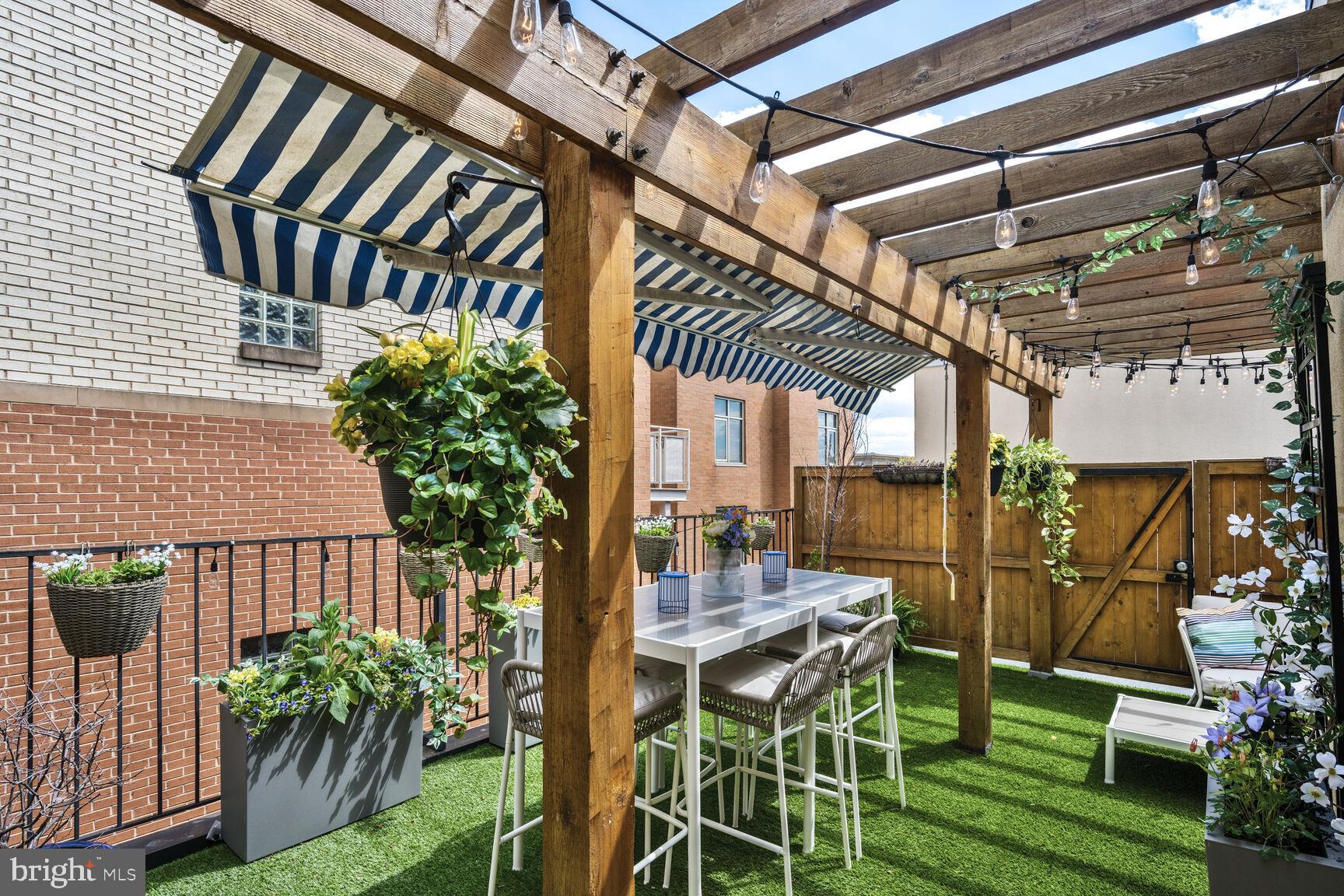 1354 Euclid Street Northwest, Unit 403A Washington, DC 20009 - Photo 18 of 26 a patio with glass top table and chairs