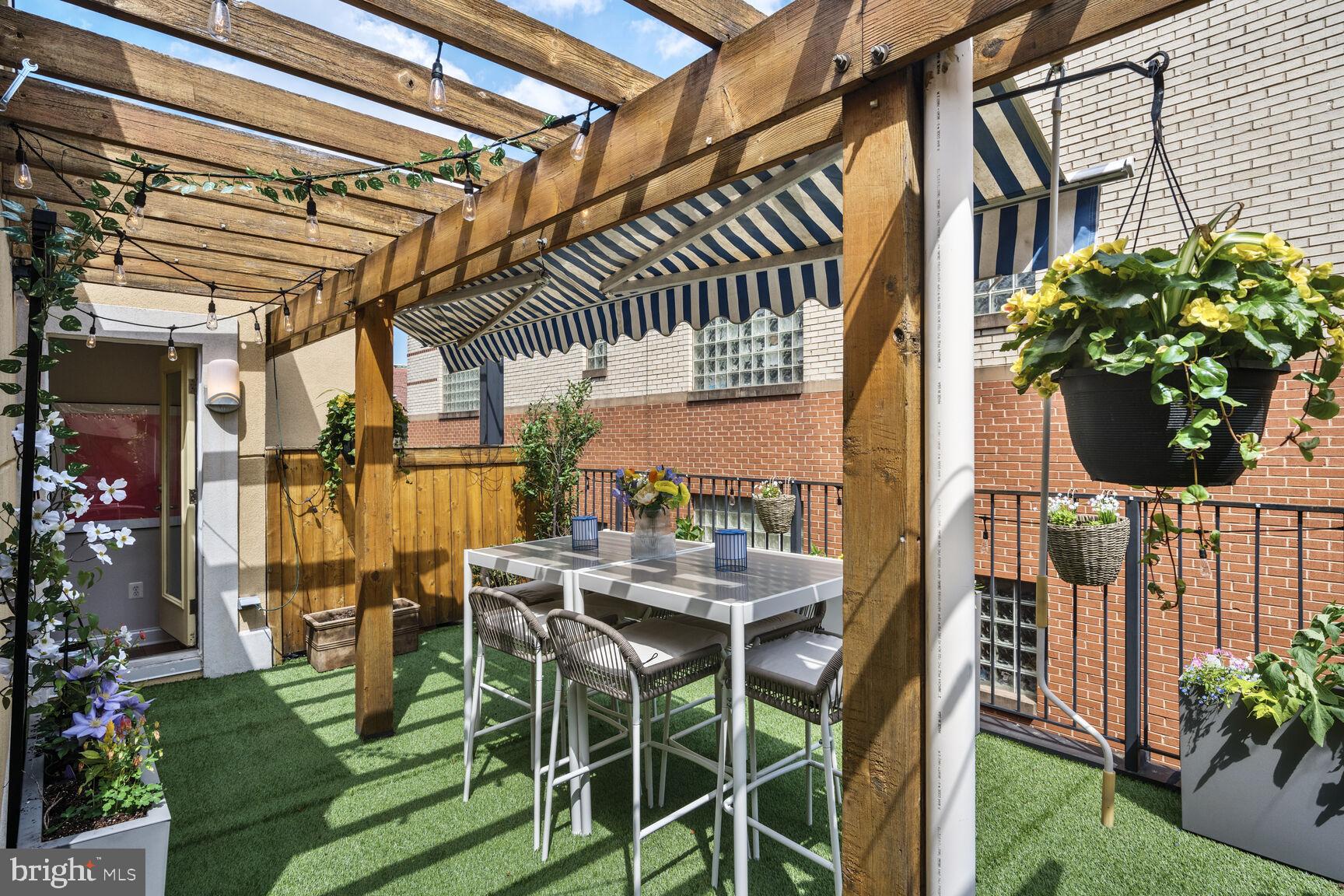 1354 Euclid Street Northwest, Unit 403A Washington, DC 20009 - Photo 20 of 26 a view of an chairs and table in patio with a garden