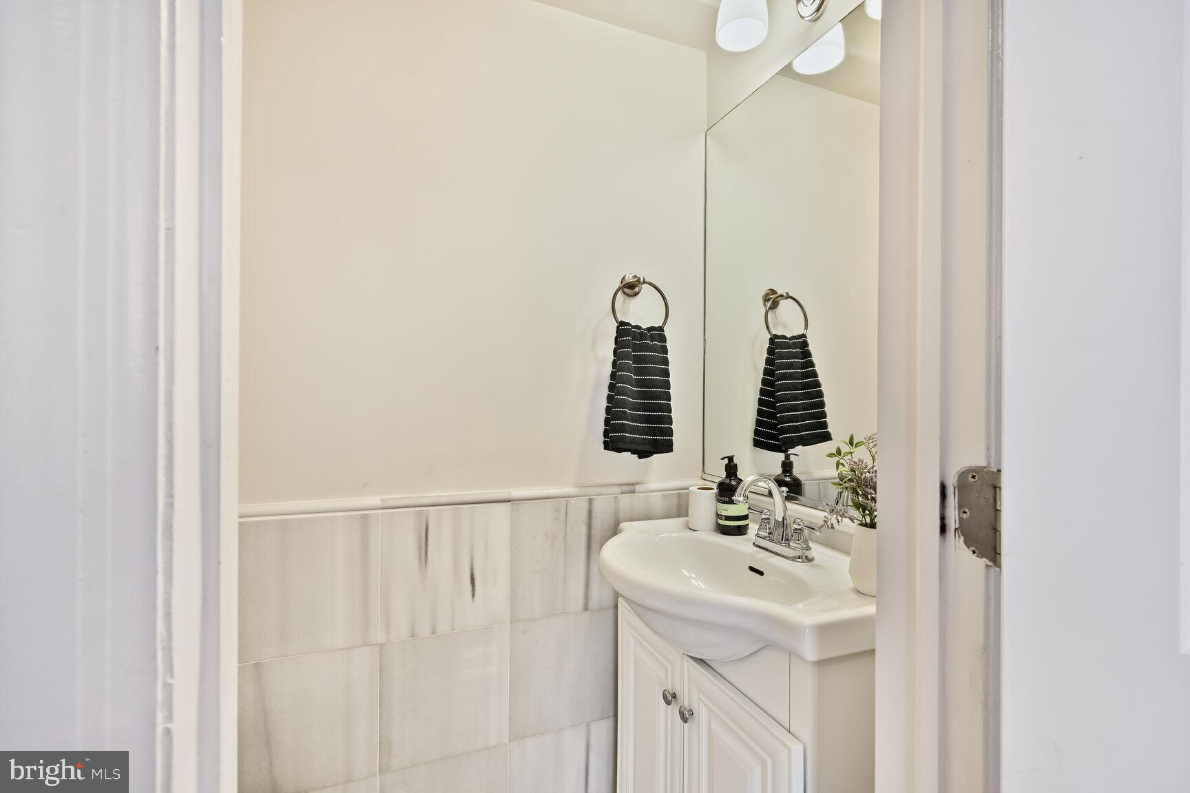 1354 Euclid Street Northwest, Unit 403A Washington, DC 20009 - Photo 6 of 26 a bathroom with a sink and a mirror