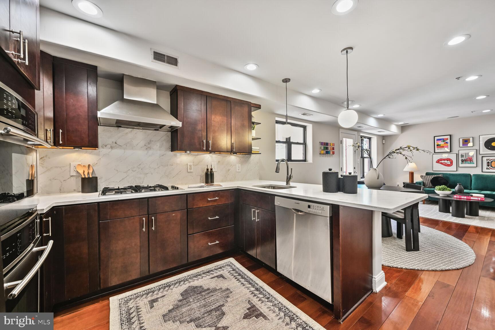 1354 Euclid Street Northwest, Unit 403A Washington, DC 20009 - Photo 7 of 26 a kitchen with stainless steel appliances granite countertop a sink a stove and refrigerator
