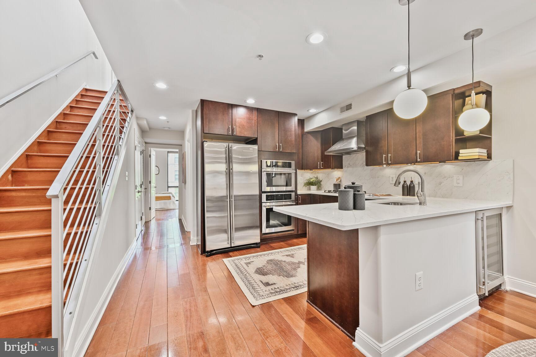 1354 Euclid Street Northwest, Unit 403A Washington, DC 20009 - Photo 9 of 26 a kitchen with wooden cabinets and a sink