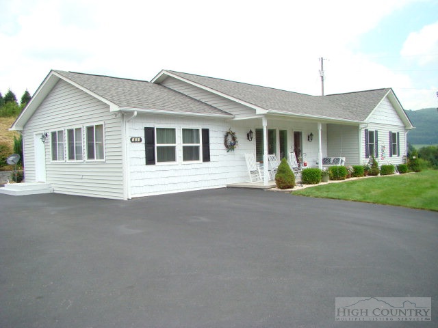 124 Alex Wellborn Road Deep Gap, NC 28618 - Photo 1 of 26 a front view of a house with a yard and garage