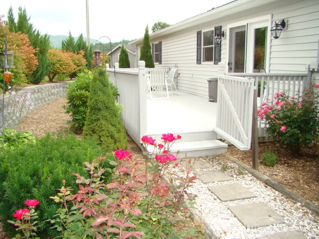 124 Alex Wellborn Road Deep Gap, NC 28618 - Photo 11 of 26 a view of a house with a yard and garden