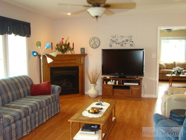 124 Alex Wellborn Road Deep Gap, NC 28618 - Photo 23 of 26 a living room with furniture a flat screen tv and a fireplace