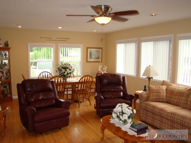 124 Alex Wellborn Road Deep Gap, NC 28618 - Photo 25 of 26 a living room with furniture ceiling fan and a window