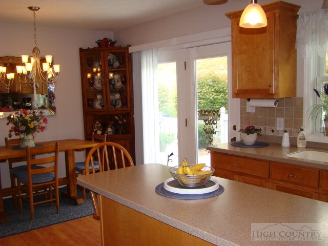 124 Alex Wellborn Road Deep Gap, NC 28618 - Photo 4 of 26 a kitchen with a table and chairs