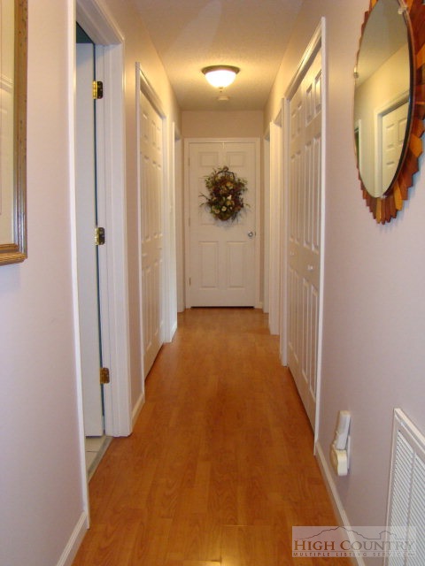 124 Alex Wellborn Road Deep Gap, NC 28618 - Photo 5 of 26 a view of a hallway with wooden floor and entryway