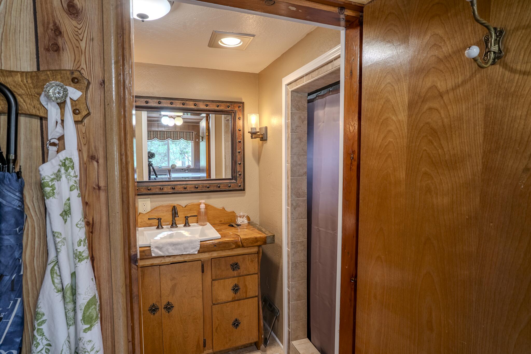 1969 Colestin Road Ashland, OR 97520 - Photo 45 of 72 a bathroom with a mirror and a shower