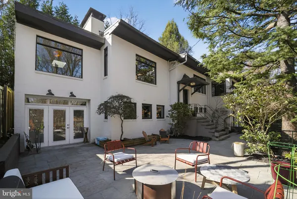 a backyard of a house with fire pit and outdoor seating