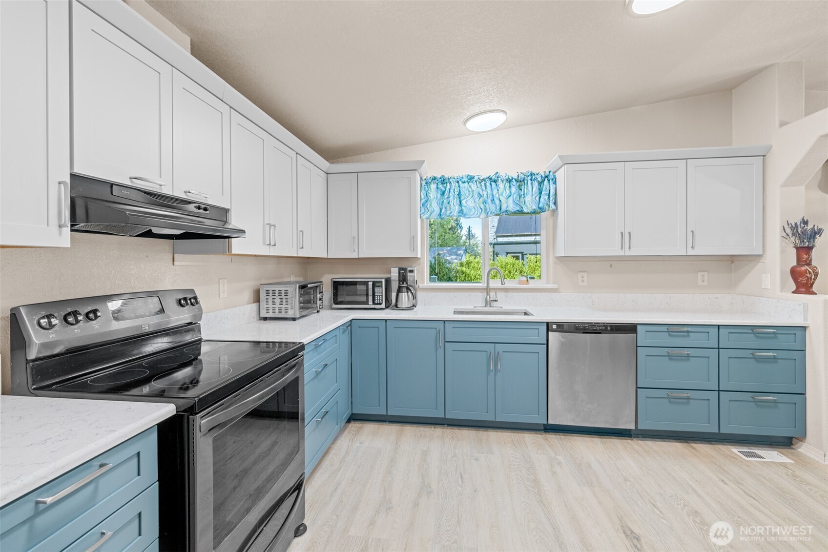 423 Fleming Drive Sequim, WA 98382 - Photo 11 of 33 a kitchen with cabinets appliances a sink and a window